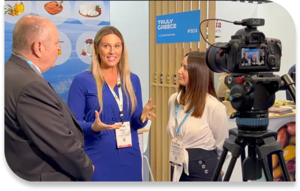 Emily Anne Page being interviewed at an international trade fair
